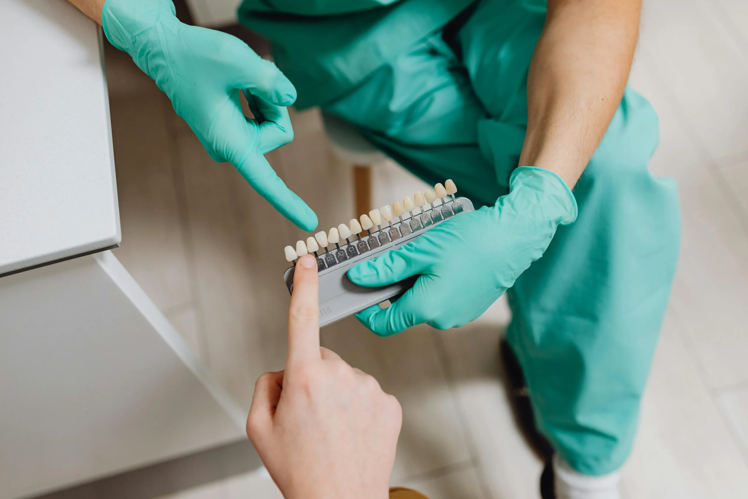 Dentist explaining dental implant treatment costs to a patient in a modern UK clinic