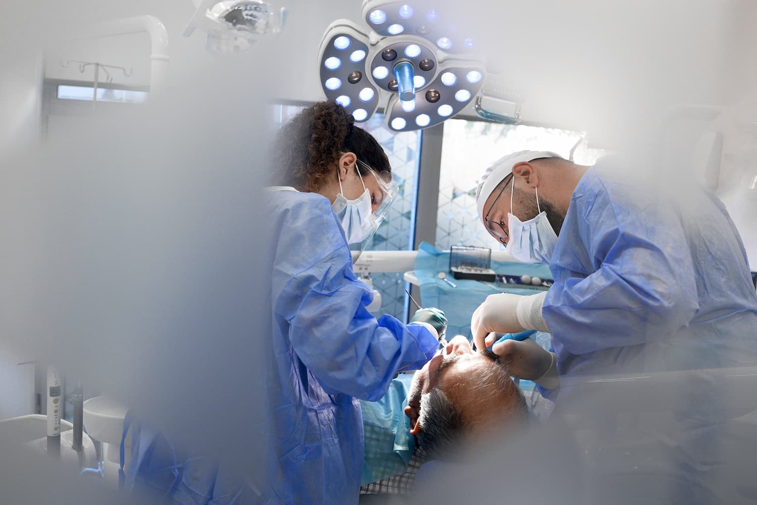 Cleaning under an All-on-4 dental implant bridge with proper implant hygiene tools
